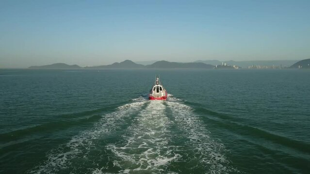Following a speed boat through the ocean. Aerial shot