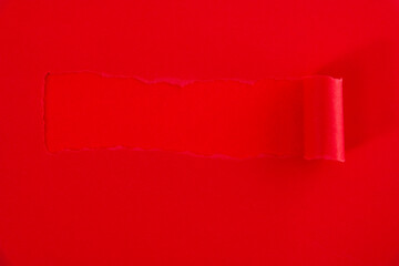 Red torn paper on red background
