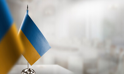 Small flags of the Ukraine on an abstract blurry background