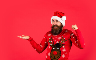 Promoting goods. Winter holiday fun. Hipster with mustache winter sweater. Stunning and Unique. Lifestyle you deserve. New year party. Christmas time. Product presentation. Bearded man santa hat