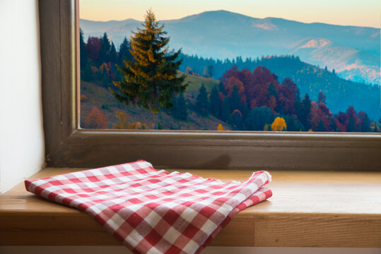 View through the window of a cottage into a snow-covered winter forest. High quality photo