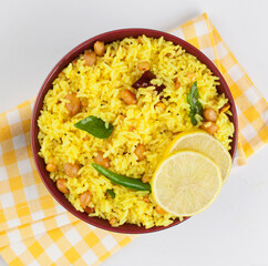 Lemon Rice or fodnicha bhat is South Indian turmeric rice or maharashtrian recipe using leftover rice garnished with nuts curry leaves and lemon juice