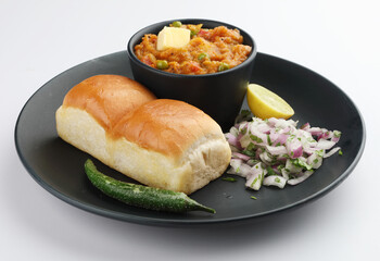 Mumbai Style Pav bhaji is a fast food dish from India, consists of a thick vegetable curry served with a soft bread roll, served in a plate