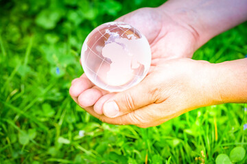 earth protection and sustainable ecology development concept - hands holding planet earth with...