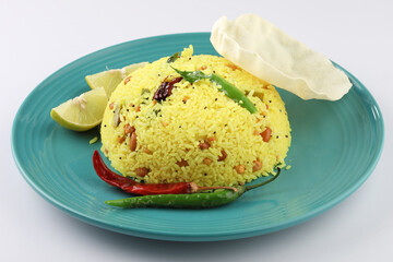 Lemon Rice or fodnicha bhat is South Indian turmeric rice or maharashtrian recipe using leftover rice garnished with nuts curry leaves and lemon juice