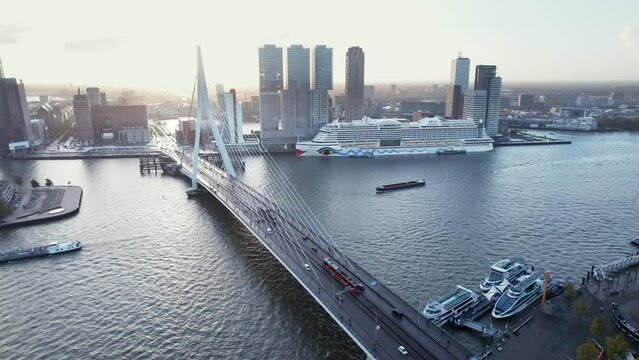 Tram And Traffic On Erasmusbrug Spanning The Nieuwe Maas With AIDA Cruise Ship Dock On Cruise Terminal Rotterdam In Netherlands. - wide