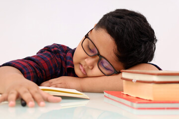 Close up photo of Tired asian school boy sleeping while studying. Isolated on white background