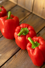 Red peppers on a wooden background