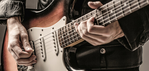 Man playing guitar. Close up hand playing guitar. Musician playing guitar, live music