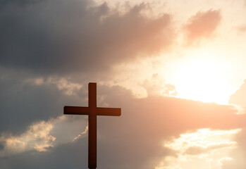 A cross under the sunset sky