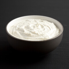 Fototapeta na wymiar Homemade Ranch Dressing in a Bowl on a black background, side view.