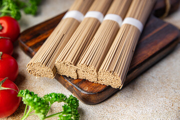 raw buckwheat noodles soba Asian snack healthy meal food snack on the table copy space food background rustic top view