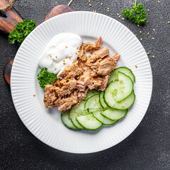 tuna salad, cucumber and yogurt or sour cream meal food snack on the table copy space food background rustic top view