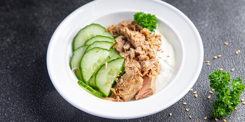 tuna salad, cucumber and yogurt or sour cream meal food snack on the table copy space food background rustic top view
