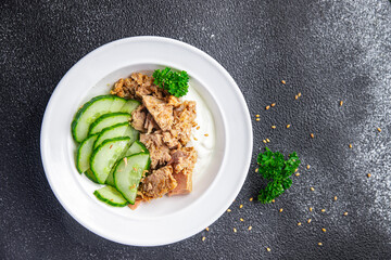 tuna salad, cucumber and yogurt or sour cream meal food snack on the table copy space food background rustic top view