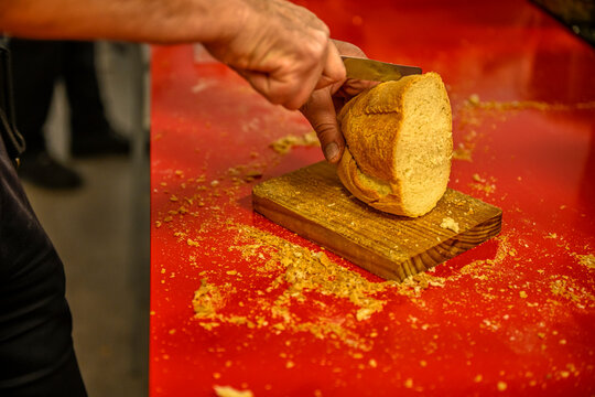 Cut A Loaf Of Bread Into Smaller Portions.