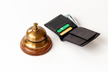 Hotel payment concept with vintage hotel service bell and wallet