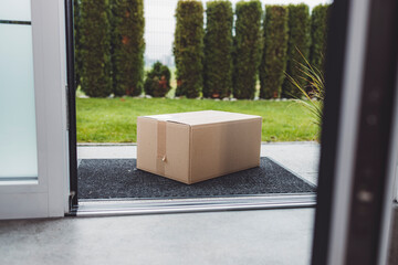 View from inside out, package sitting at the front door waiting to be picked up 