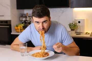 Man eating pasta with bad manners 