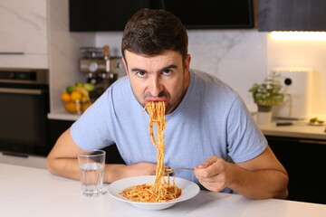 Man eating pasta with bad manners 