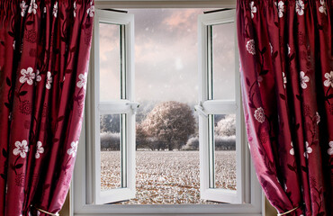 Looking through open window on to winter landscape