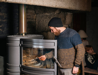 man lighting a fireplace in the house