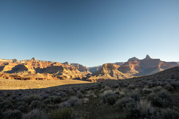 Fototapeta na wymiar Backpacker HIkes In The Shadows Of The Tonto Trail In Grand Canyon
