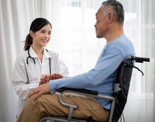 Senior man patient is in wheelchair and young female nurse taking care of him in nursing home. Asian doctor woman supports old man patient to recovery at hospital. Aged people at rehabilitation.