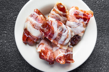 dates in bacon snack smoked meat dry-cured meal food snack on the table copy space food background rustic top view