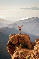 Sportive young girl overlooking the amazing views of Nublo Rural Park and Mount Teide in the...