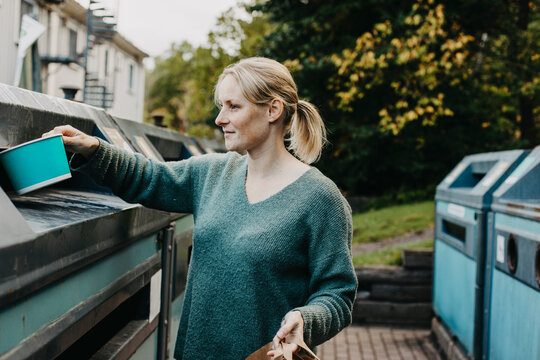 Woman recycling rubbish