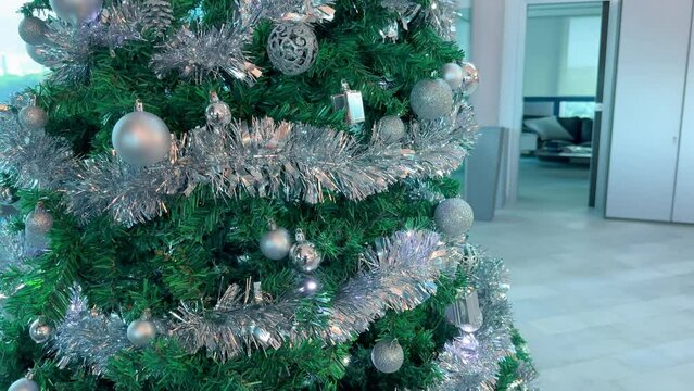 Beautiful Christms Tree with decorations in a modern office interior. Business and holidays concept