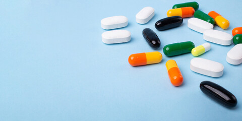 Top view of different pills on blue background,large banner with