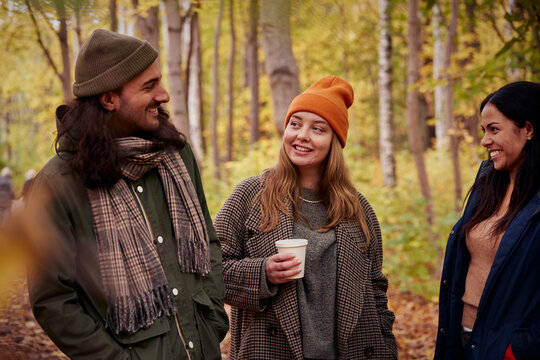 Friends talking in autumn forest