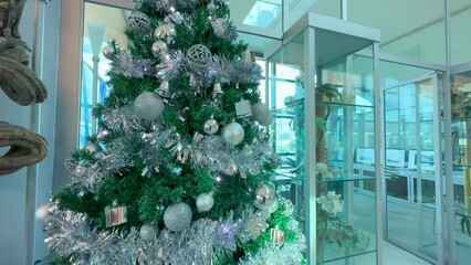 Beautiful Christms Tree with decorations in a modern office interior. Business and holidays concept - Powered by Adobe