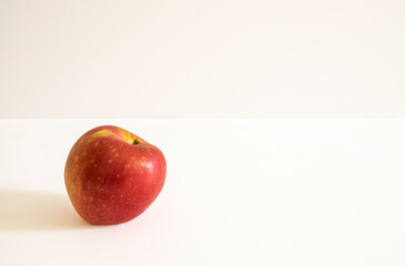 A fresh red apple on a white background.