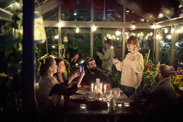 Friends having evening meal together