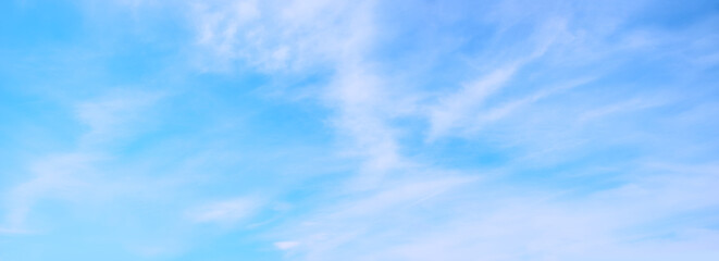 soft wide blue sky background with fluffy ciouds