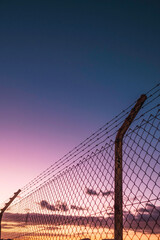 Obraz premium cross-border fence at sunset.border between countries.