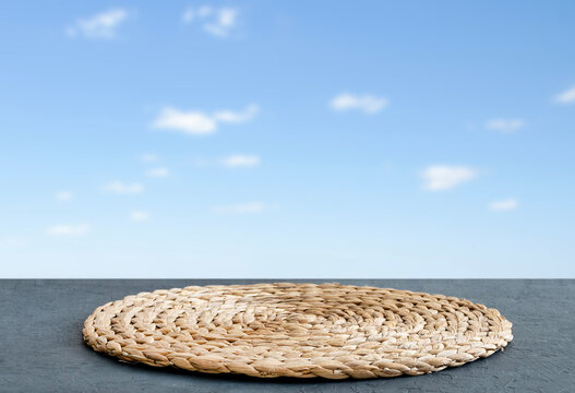 Wooden Blue Tabletop With  Napkin And Free Space For Installing A Product Or Layout On A Background Of Blue Sky With Clouds.