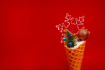 Ice Cream Cone with Christmas Decoration on red background. Minimal Christmas Concept