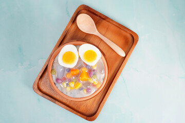 Thai desserts with coconut milk and small rolls and cooked eggs (Khanom Bua Loi)