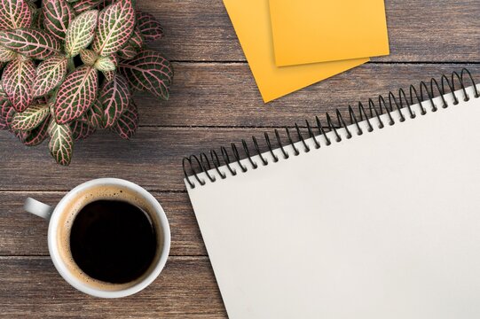 Concept of new goals on notebook and coffee cup
