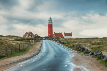 the lighthouse of the island texel in holland - obrazy, fototapety, plakaty