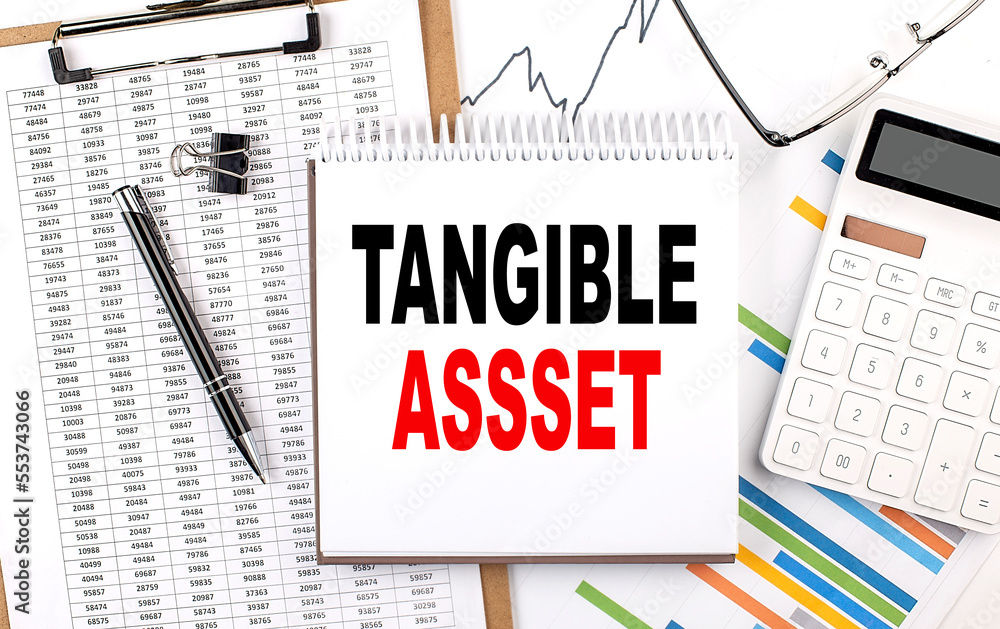 Poster tangible assets text on notebook with chart, calculator and pen