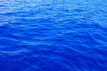 Very nice sea water background or backdrop with selective focus. Small waves of natural water surface texture.