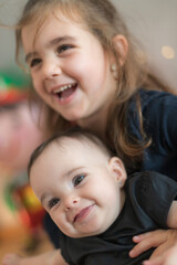 Two cute little sisters having a good time at home