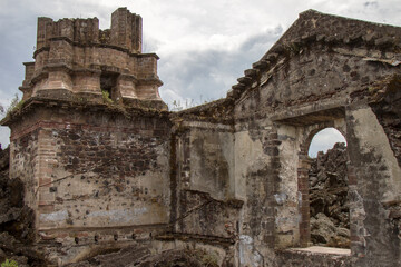 A church buried by lava of the Paricutín volcano in Parangaricutirimucuaro, Michoacan, Mexico. The ruins of an old church.  Bell tower. 