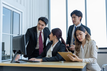A group of young Asian businessmen Talking and planning work happily and have fun. at the company's office