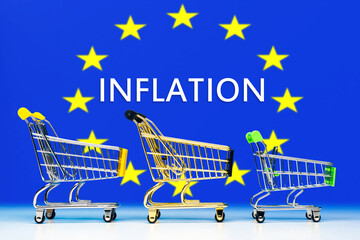 Inflation in European Union. Supermarket carts symbolize food inflation. Flag of Europe with word inflation. Rising prices in European Alliance. Reducing value of euro. Crisis Inflation. 3d image.